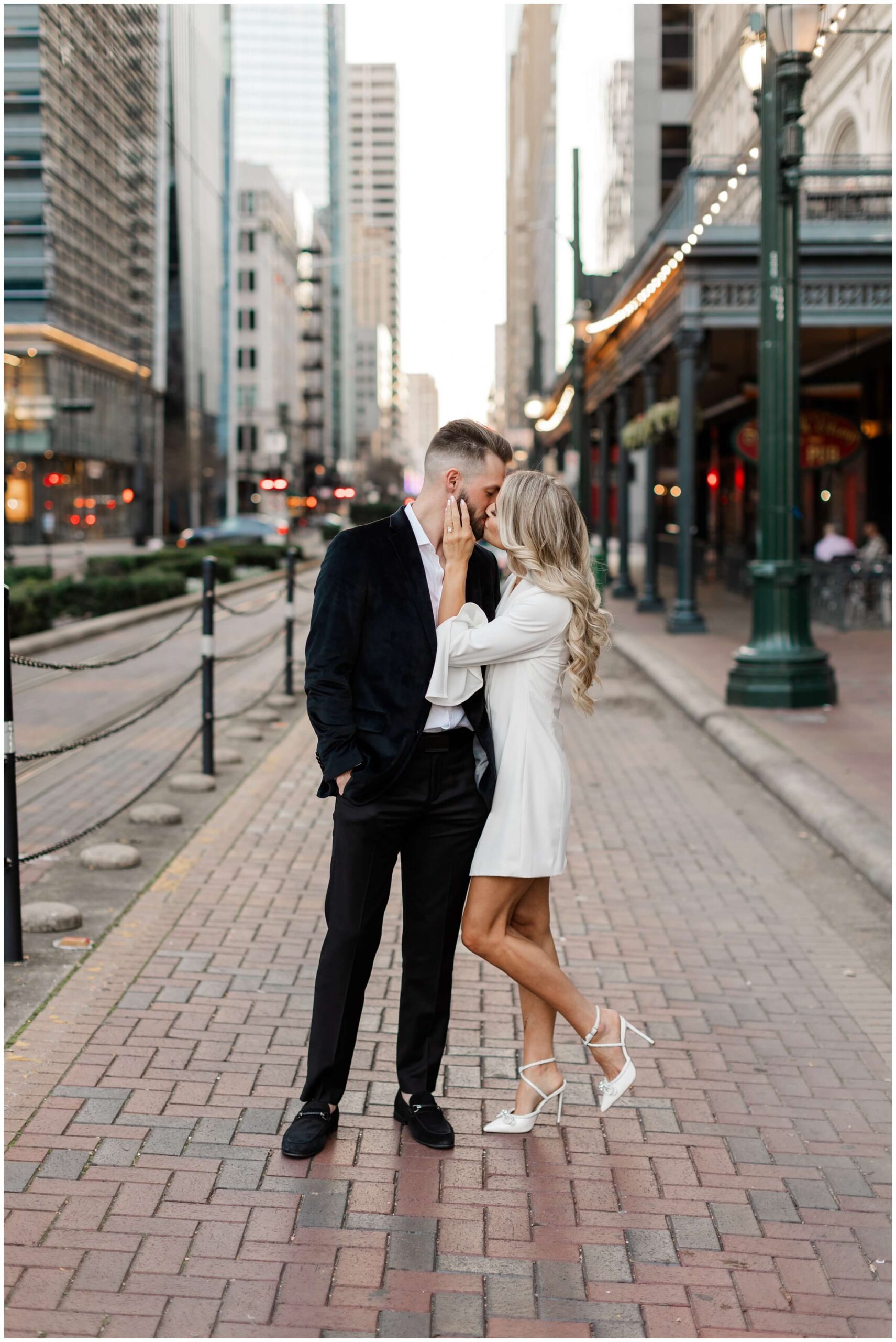 a couple stroll through the city streets for their Houston engagement photos