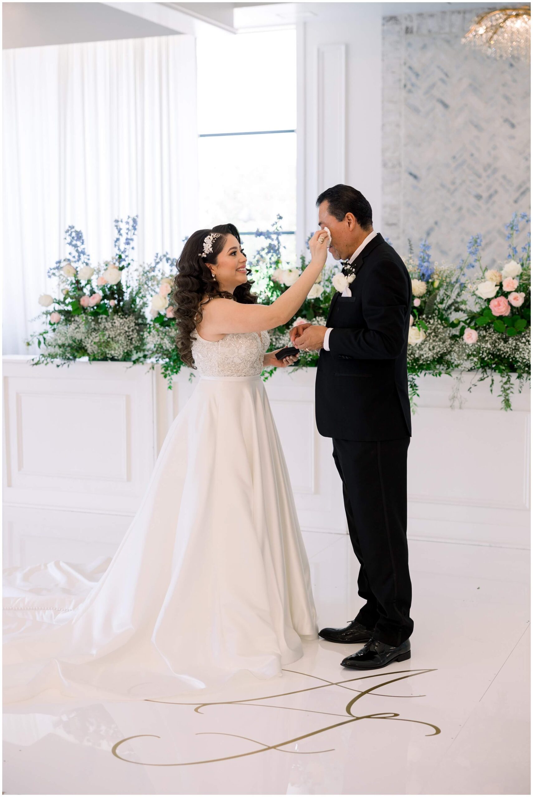 The bride shares a first look with her father at the Peach Orchard venue