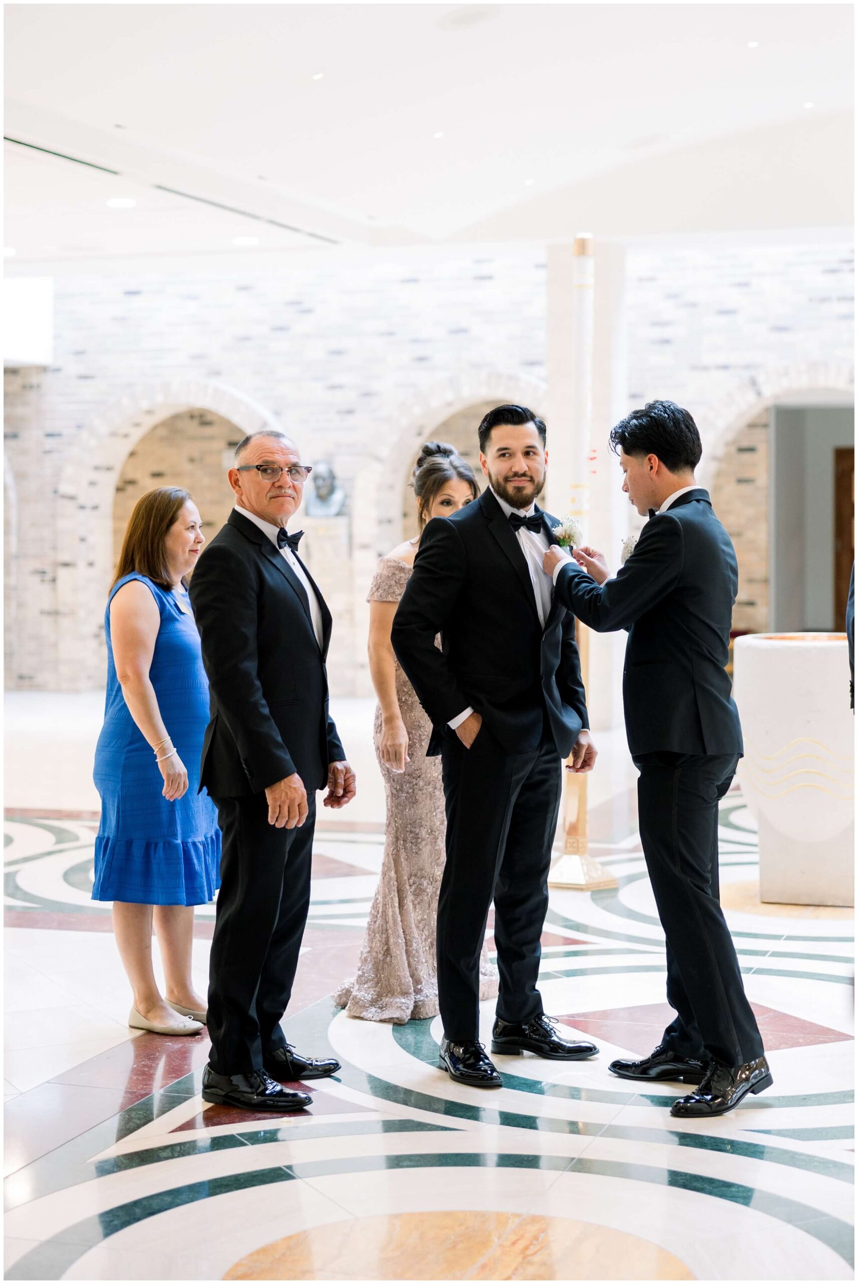 the groom gets ready with his family at saint john vianney catholic church