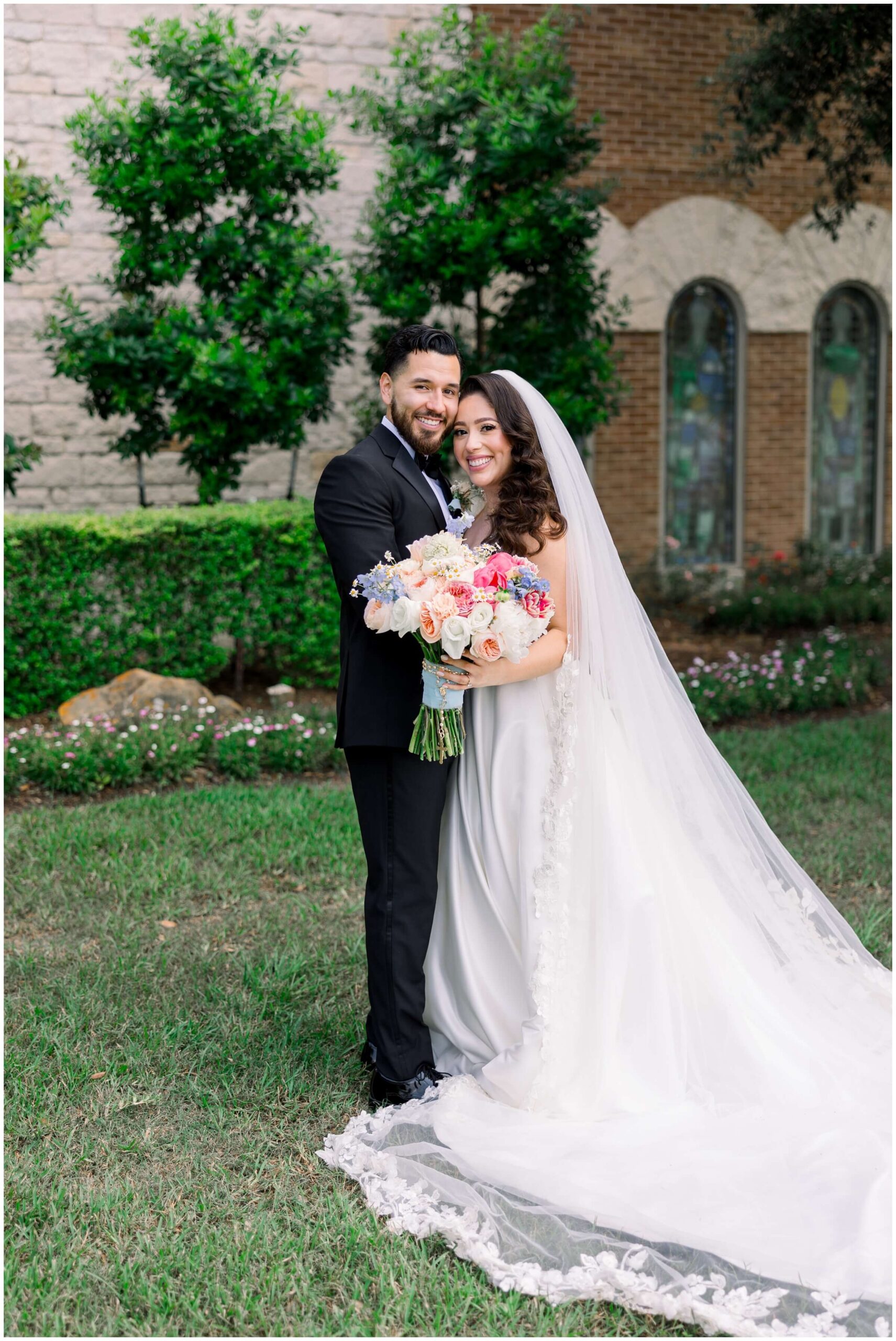 The bride and groom smile together