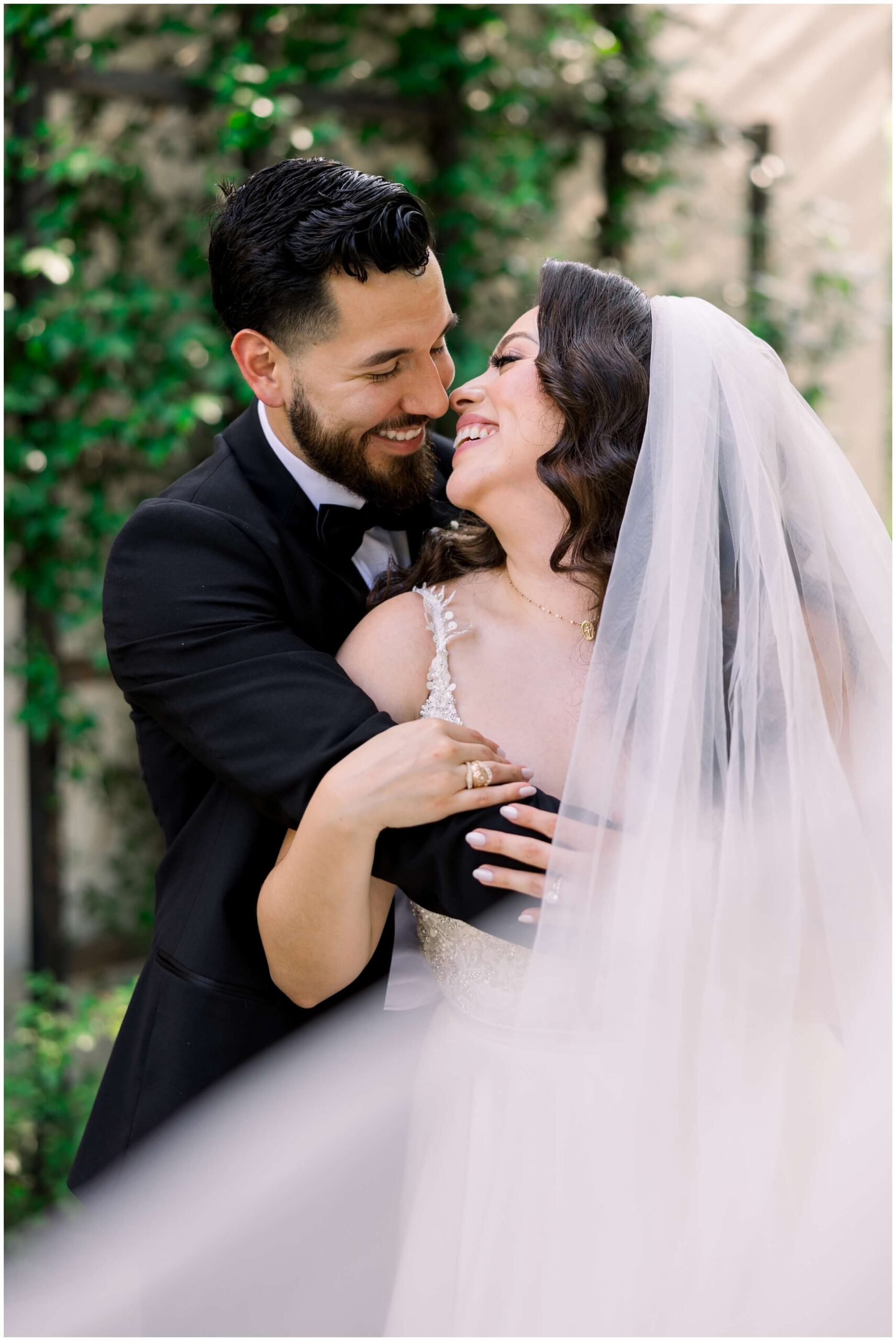 The bride and groom smile together at the Peach Orchard venue