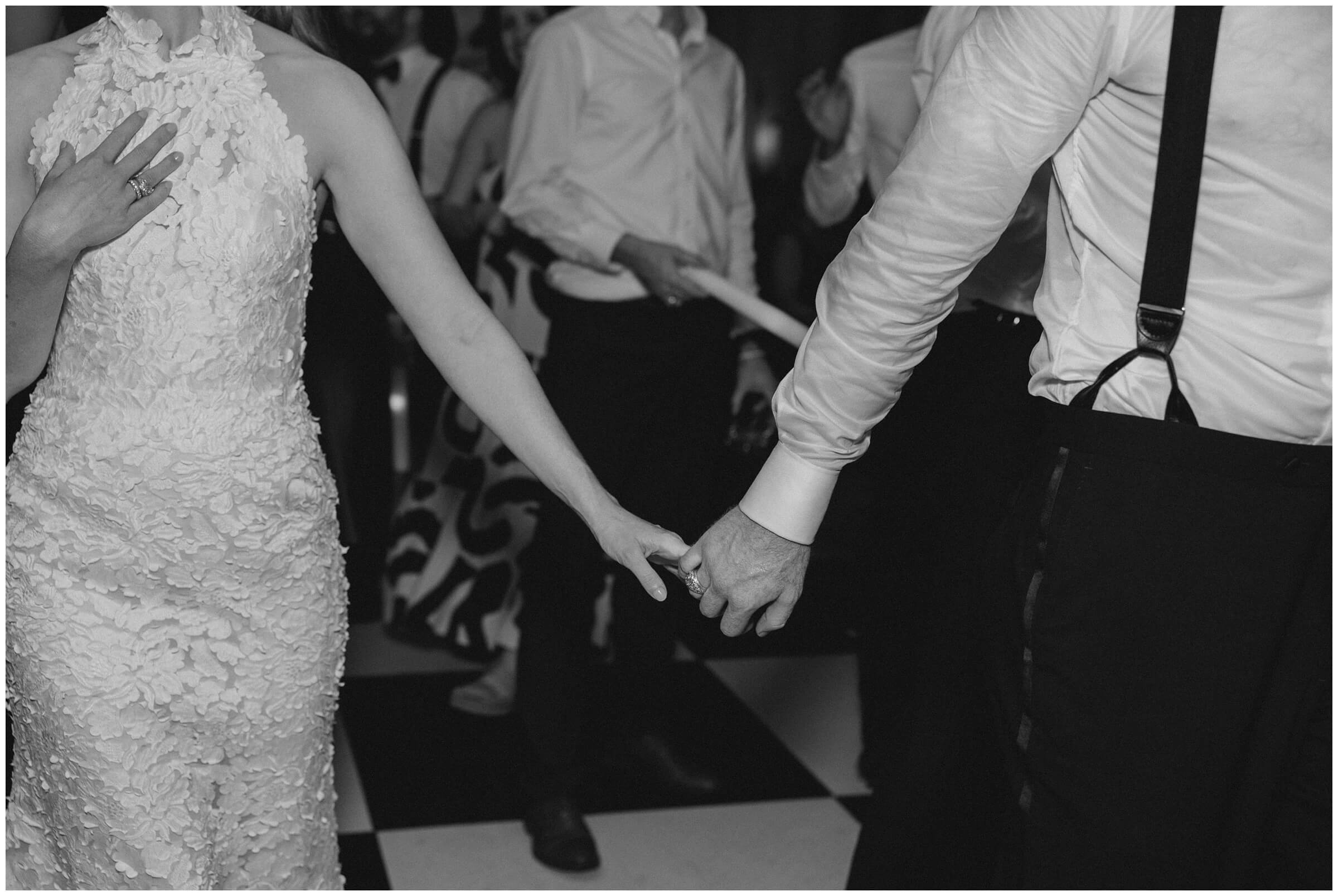 Bride and groom dancing surrounded by guests at Colonial Country Club wedding