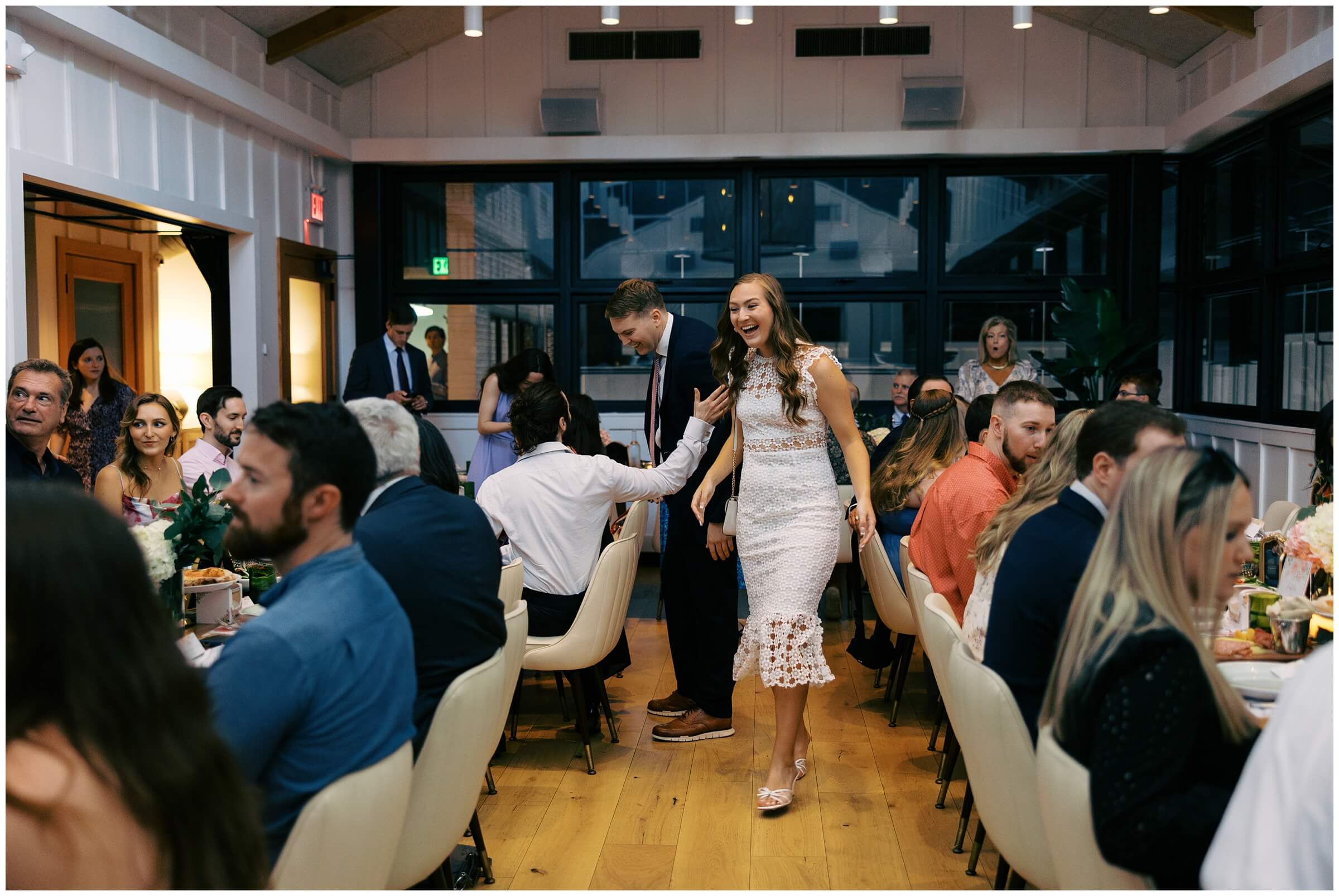 Maddie and Tucker celebrating with family during their rehearsal dinner at Sixty Vines in The Woodlands — photographed by Westy Peck, Houston wedding photographer.