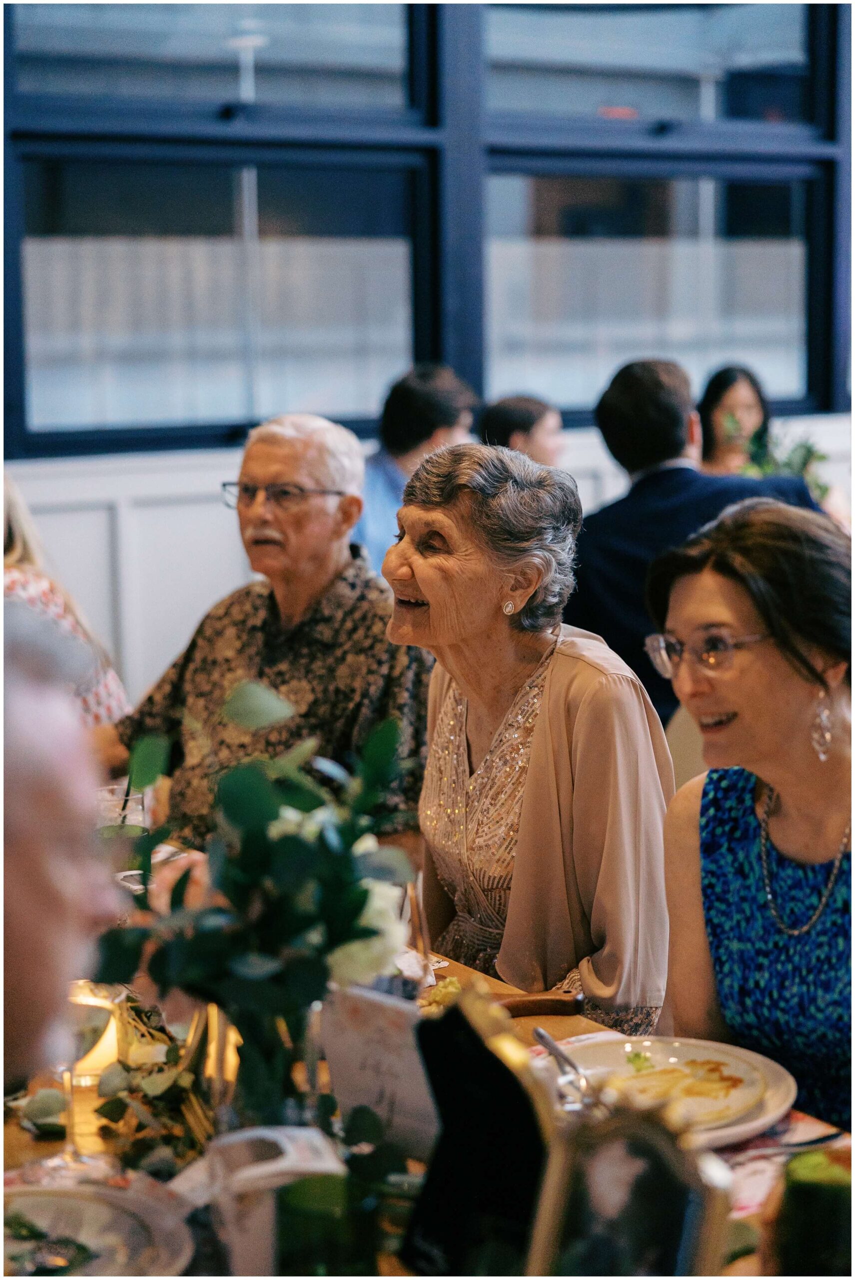 Maddie and Tucker celebrating with family during their rehearsal dinner at Sixty Vines in The Woodlands — photographed by Westy Peck, Houston wedding photographer.