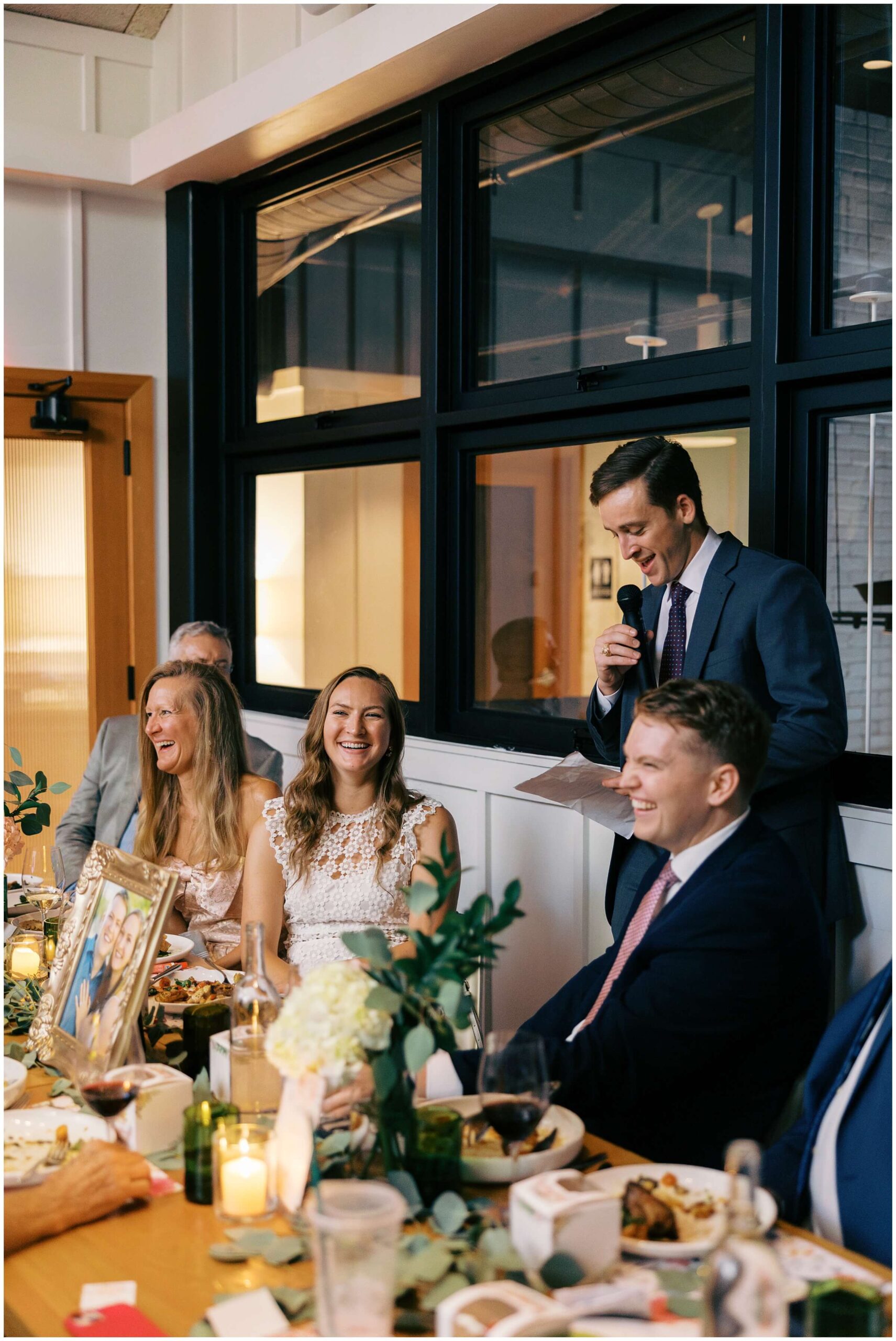 Maddie and Tucker celebrating with family during their rehearsal dinner at Sixty Vines in The Woodlands — photographed by Westy Peck, Houston wedding photographer.