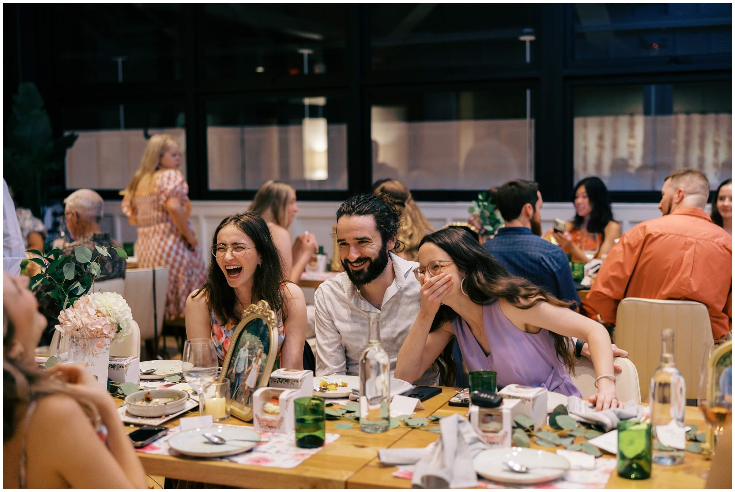 Maddie and Tucker celebrating with family during their rehearsal dinner at Sixty Vines in The Woodlands — photographed by Westy Peck, Houston wedding photographer.