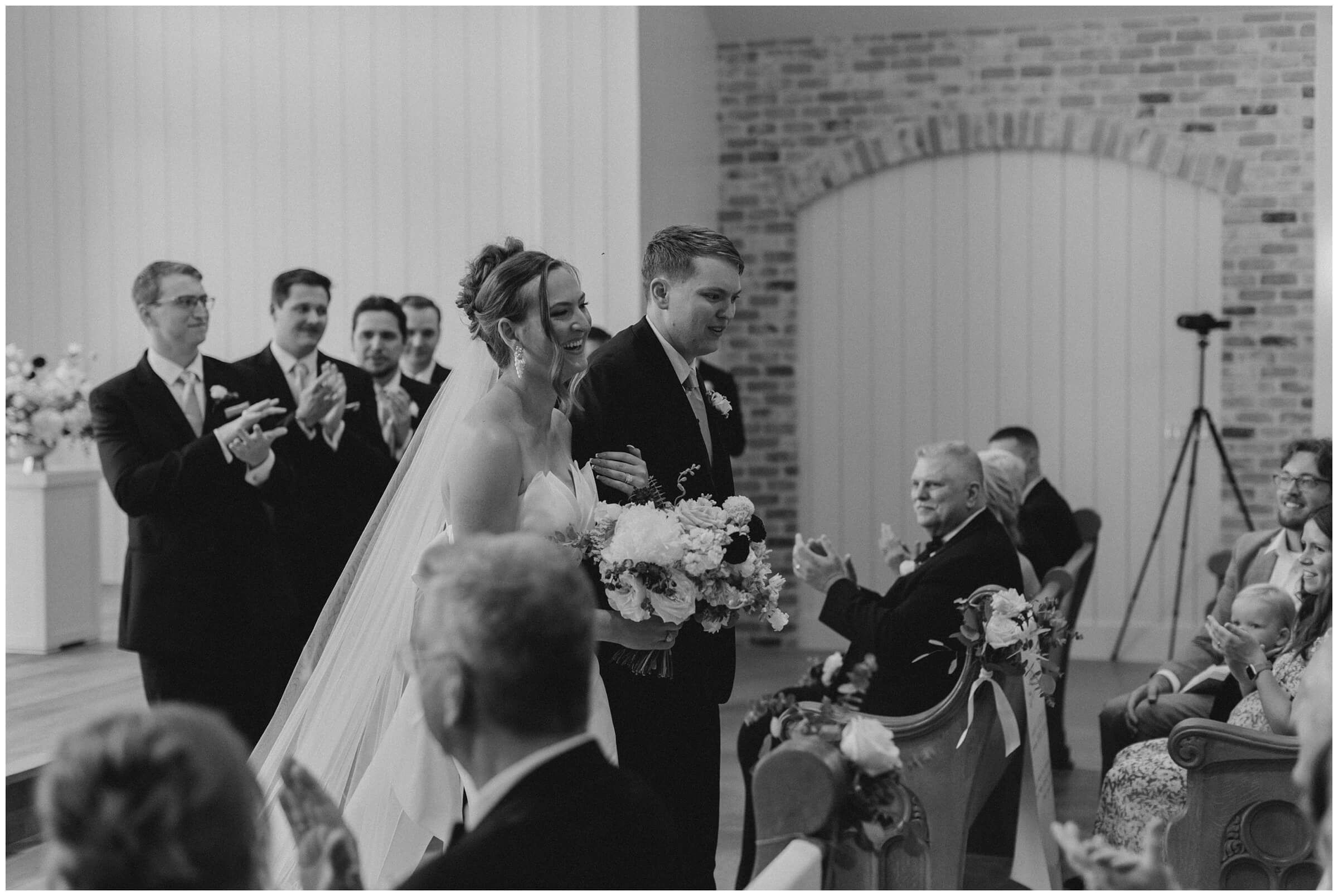 Ceremony at The Blue Magnolia featuring colorful florals by Rose and Rae.
