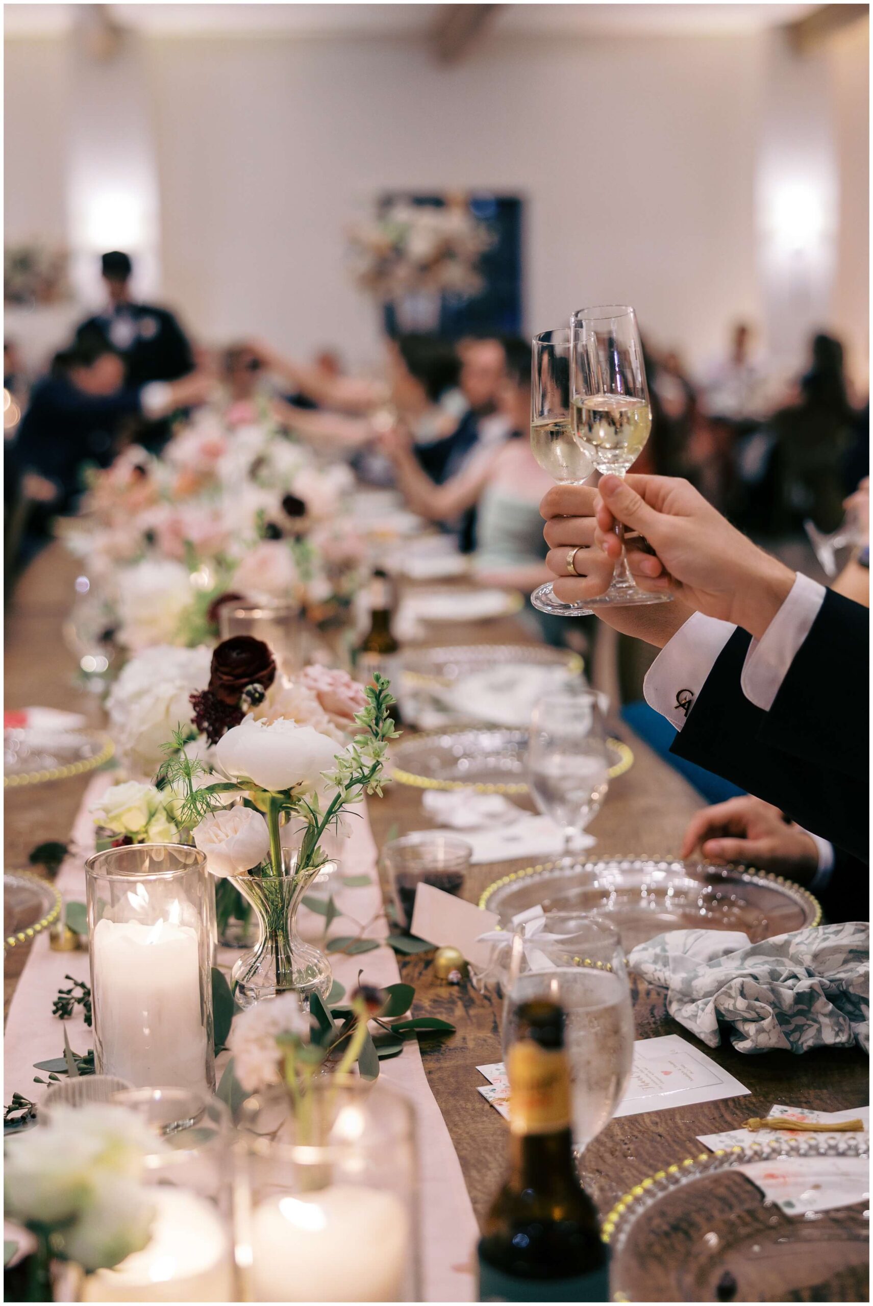 Candlelit dinner setup with colorful florals and elegant table design.
