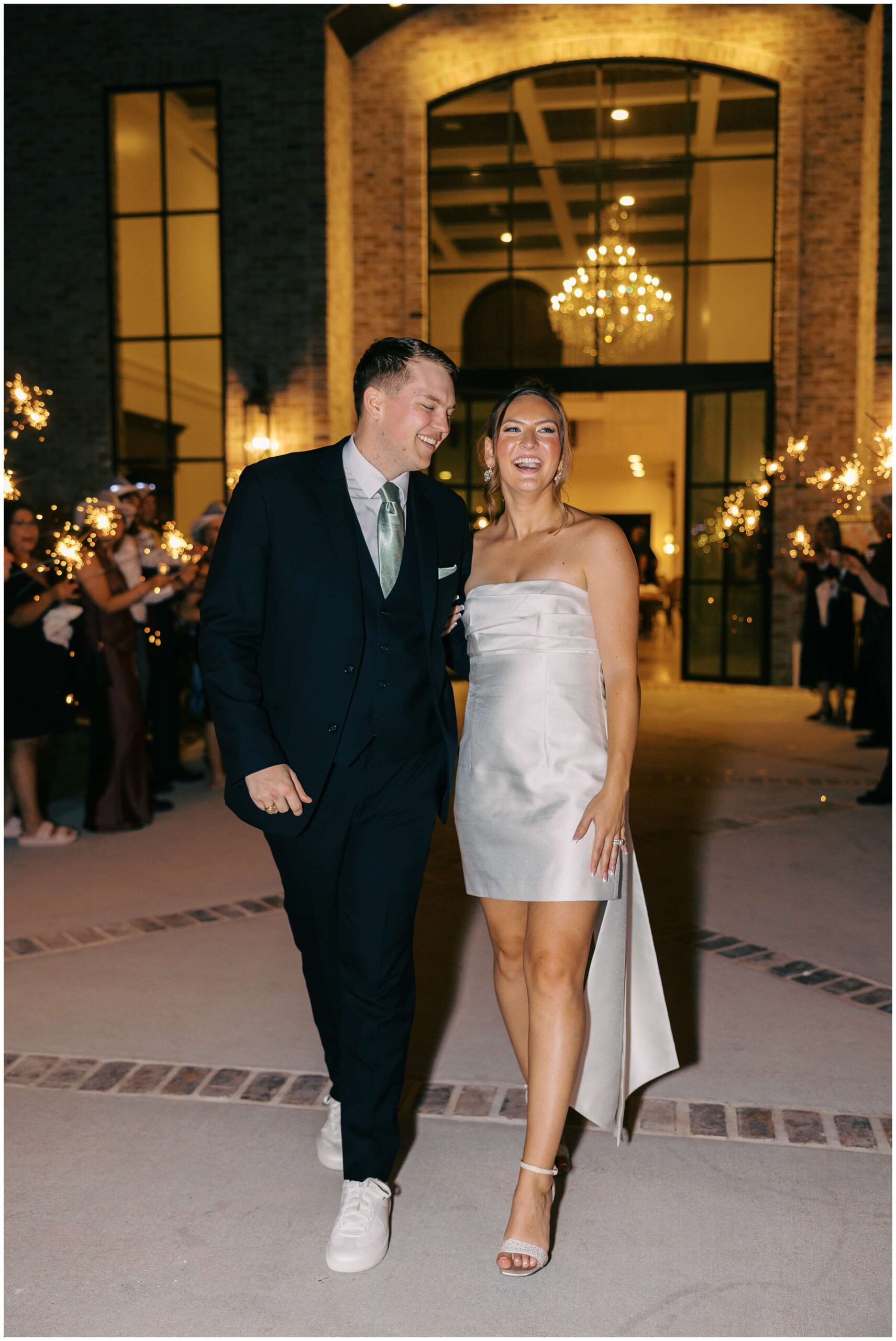 Sparkler exit at The Blue Magnolia with guests cheering for Maddie and Tucker.