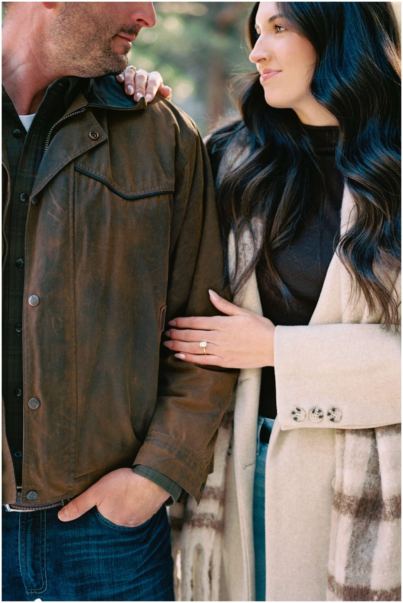 A couple smiles together in the mountains of New Mexico.