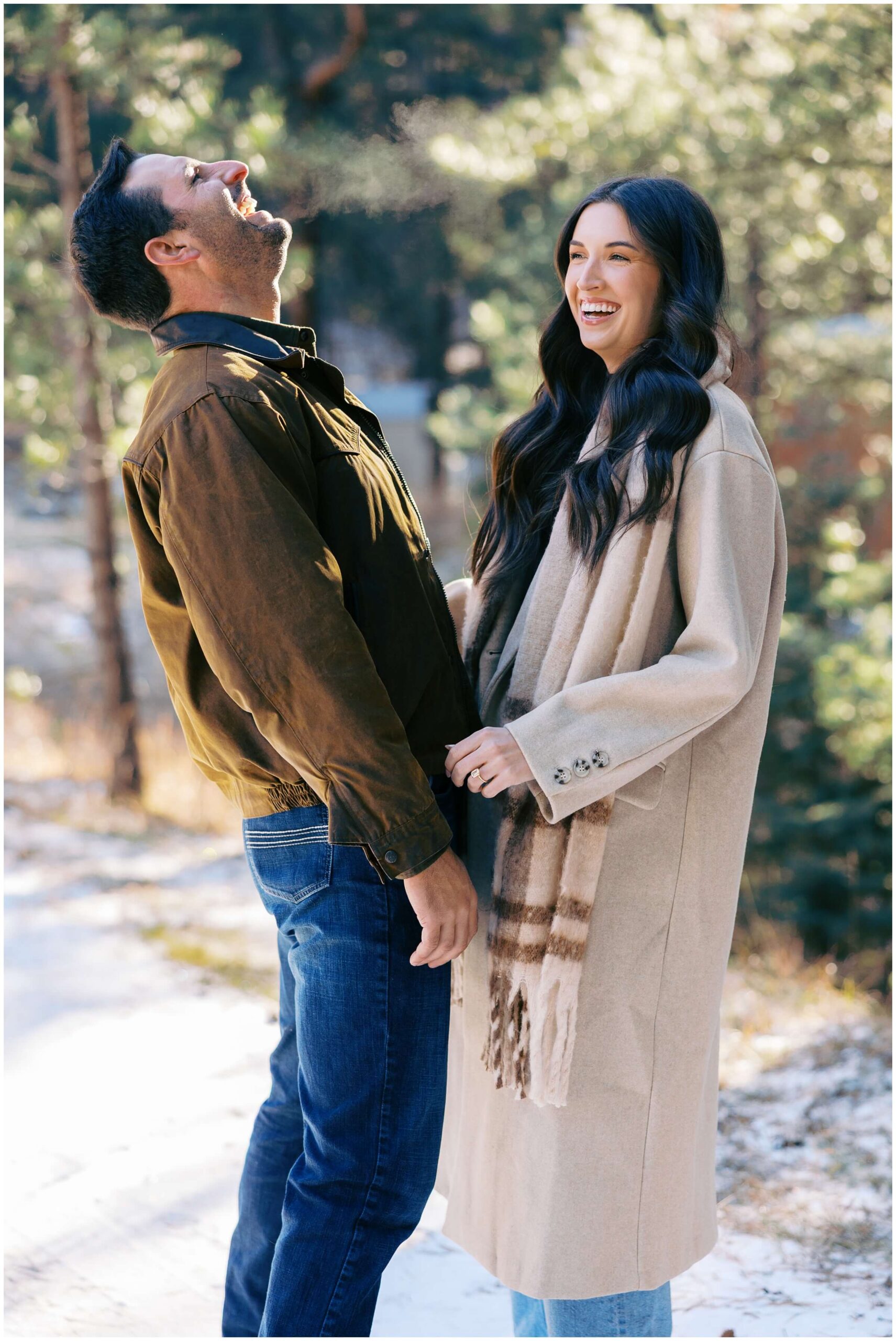 A couple laughs together in the mountains of New Mexico.