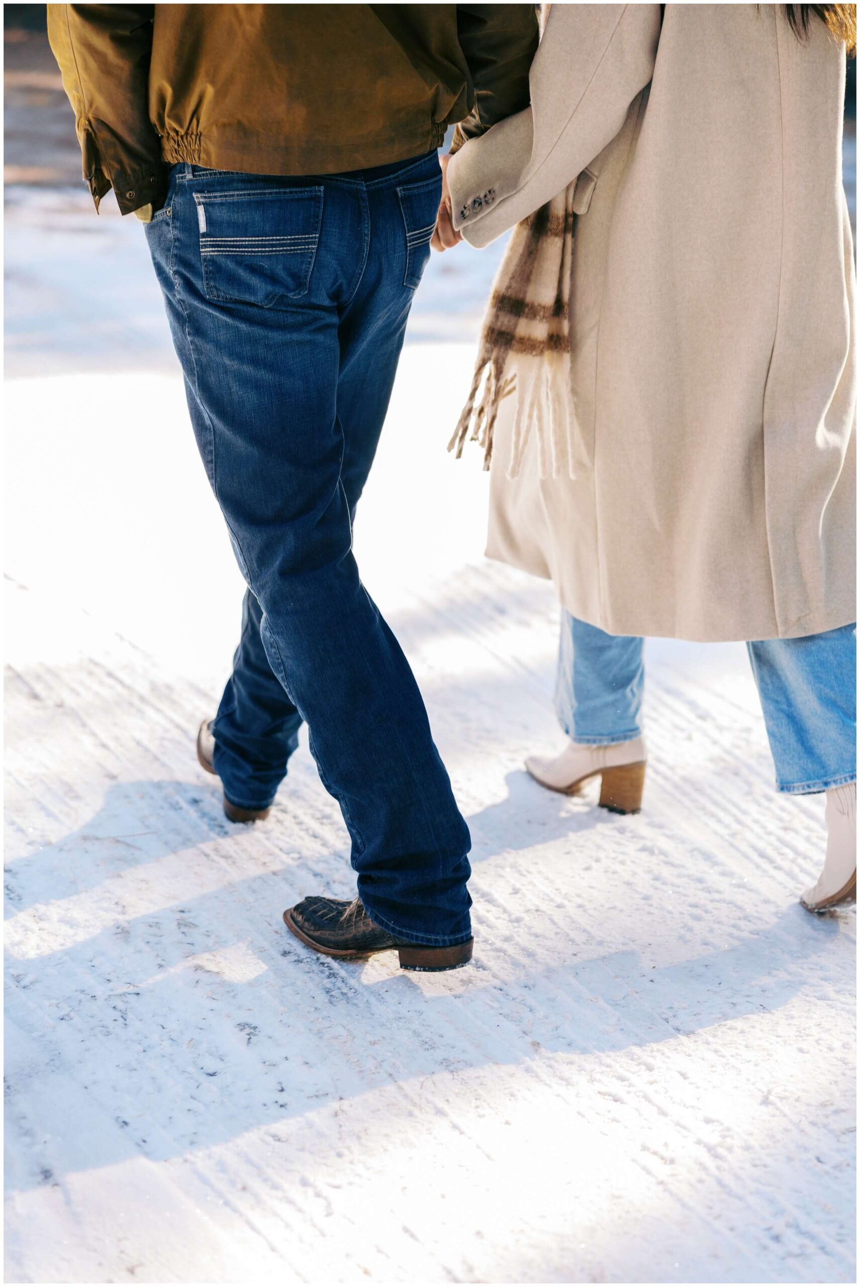 A couple walks hand in hand, in the mountains of New Mexico.