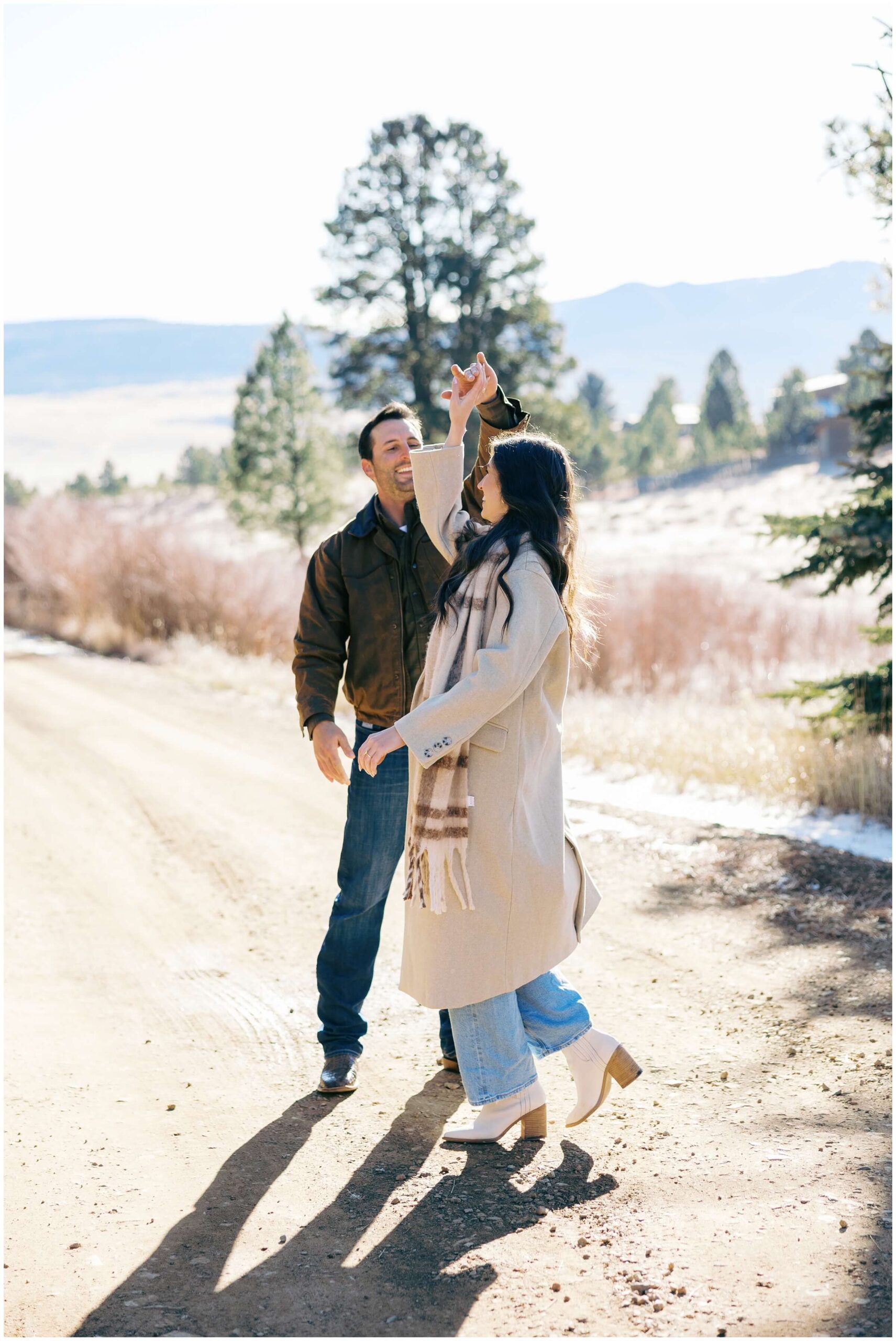 A couple dances together during their  mountain engagement session in the mountains of New Mexico.