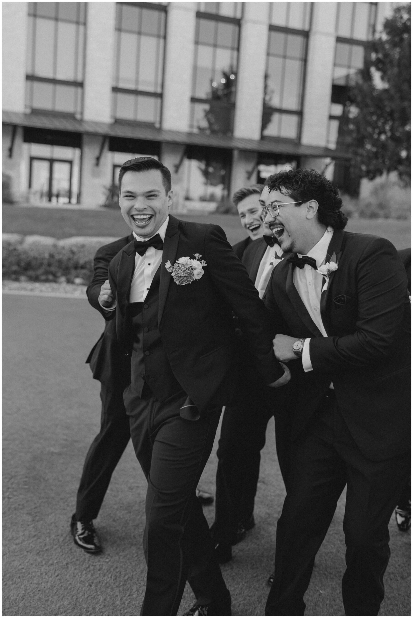a groom and his groomsmen getting ready at the omni barton creek