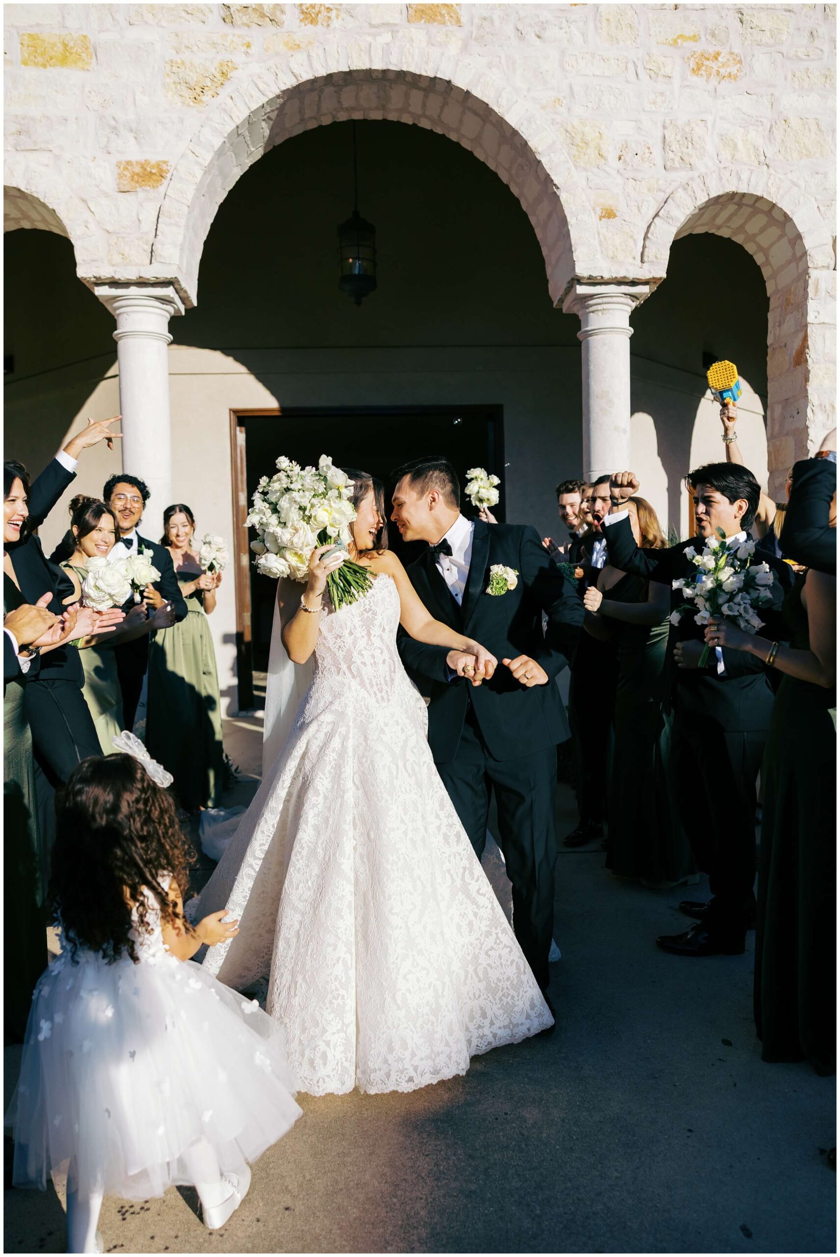 A bride and groom celebrate with their wedding party in Austin, Texas
