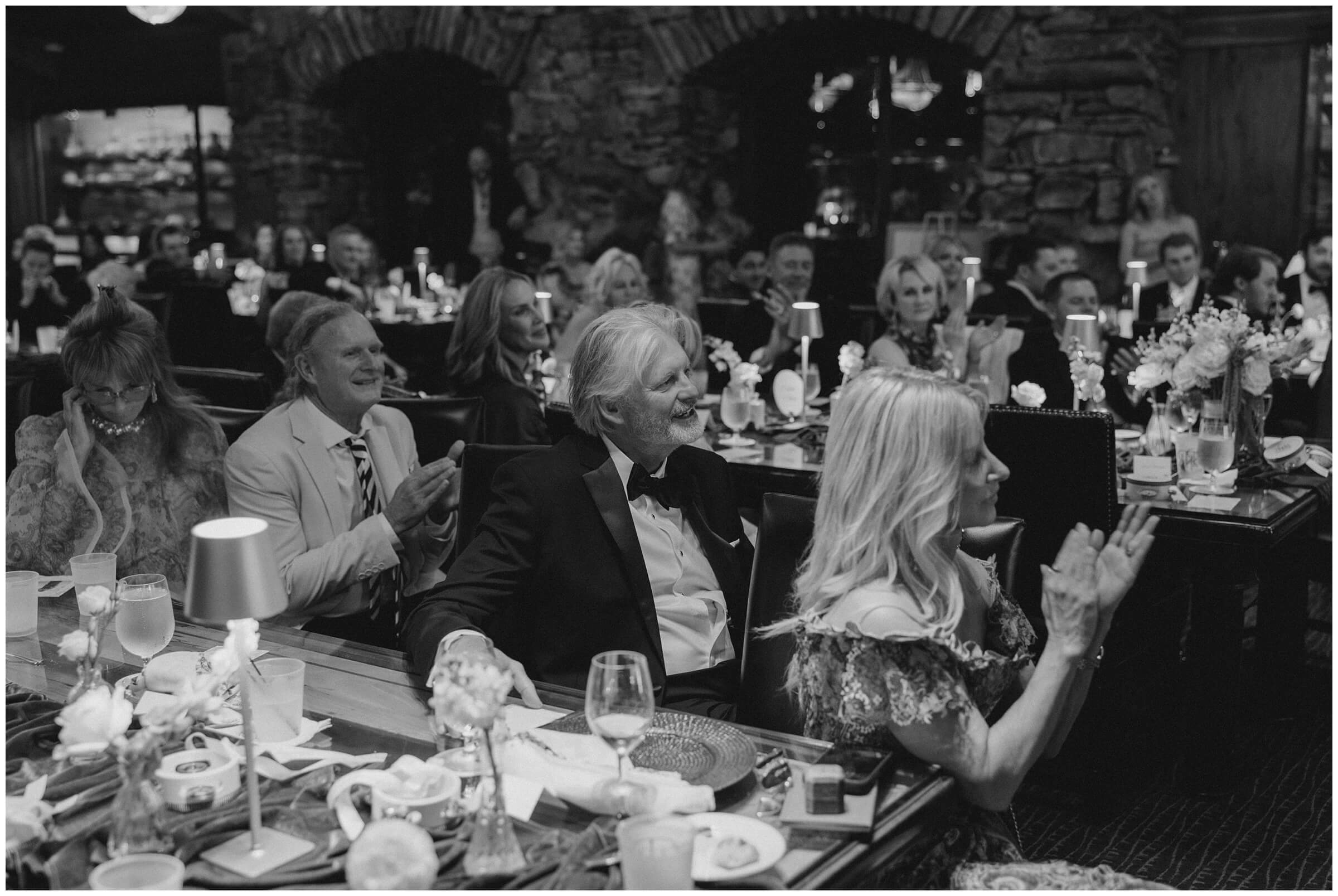 Destination Wedding photographer | Guests celebrating the couple at the wedding reception at the wine cellar of top of the rock